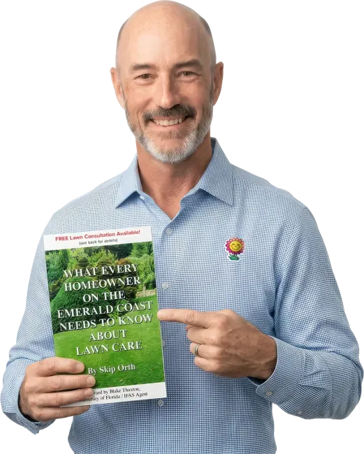Skip Orth, Owner, holding his FREE Guide to lawn care